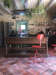 a kitchen with a wooden table and two red chairs at Dealettante in Bétaucourt