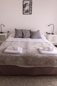 a bedroom with a large bed with two towels on it at Can Patllari in Banyoles