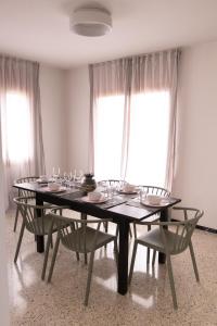 a dining room table with chairs and glasses on it at Can Patllari in Banyoles +30 photos