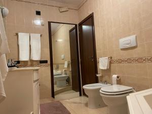 a bathroom with a toilet and a sink at Residence Don Turi in Villafranca Tirrena +15 photos