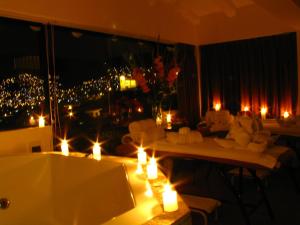 a room with candles and couches in a room with a window at Hotel Encantada Casa Boutique Spa in Cusco