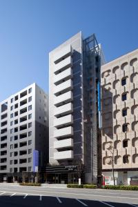 two tall buildings with a street in front of them at Daiwa Roynet Hotel Tokyo Akabane in Tokyo