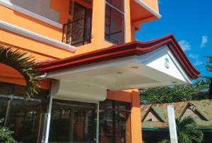an orange building with an awning on it at Ocean Villa in Iloilo City