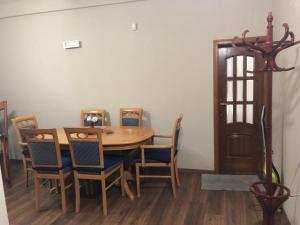 a dining room with a wooden table and chairs at Kris's apartment in Lezhë