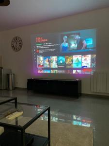 a large screen on the wall of a room at Super appartement 45 m2 proche Paris in Montreuil