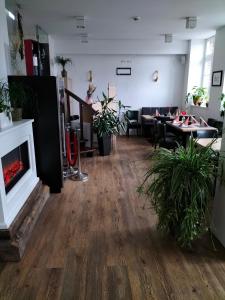 a living room with a fireplace and a table at Wachtendonker Hof in Wachtendonk