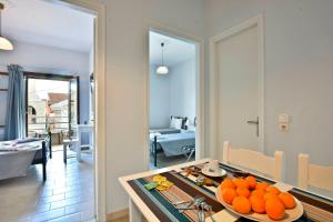 a kitchen with a table with oranges on it at Kerkyra Apartments in Roda