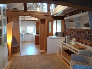 a kitchen with a counter top and a kitchen with a counter top at Ferienhaus "Landhaus Am Hirtzborn" in Marbach