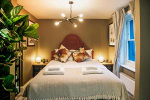 a bedroom with a large bed with two pillows at Maris and Otter in Brighton & Hove