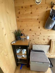 a kitchen with a stove and a wooden wall at Zinipi Retreat am Murner See in Wackersdorf