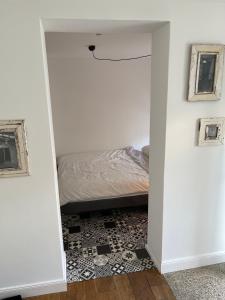 Schlafzimmer mit einem Bett und einer Tür, die in ein Zimmer führt in der Unterkunft Kleines, gemütliches Haus in Bonn in Bonn