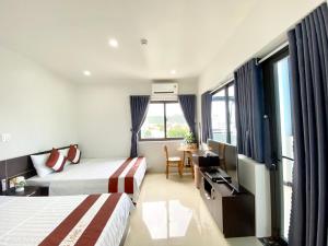 a hotel room with two beds and a table at Thăng Long Hotel in Con Dao +19 photos