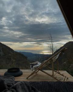 a chair sitting on a deck with a view at Horizon Lodge Medurec in Ulcinj