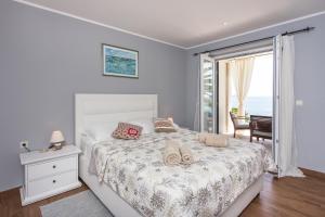 Posteľ alebo postele v izbe v ubytovaní Apartments Villa Mirjana