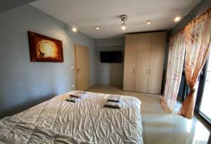 ein Schlafzimmer mit einem Bett mit zwei Handtüchern darauf in der Unterkunft Prosilio Apartment in Thessaloniki