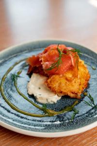 a blue plate with food on a table at Townhouse Dresden in Dresden