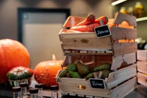 a display of pumpkins and vegetables in wooden crates at Townhouse Dresden in Dresden
