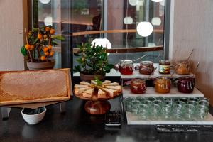a table with food and jars of jam and fruit at Townhouse Dresden in Dresden