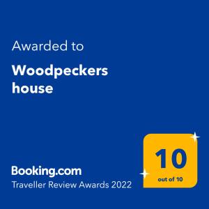a yellow sign with the words awarded to woodpeckers house at Woodpeckers house in Zlatibor