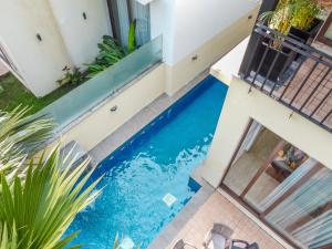 a swimming pool in the middle of a house at Luxury Villa Goa in Candolim