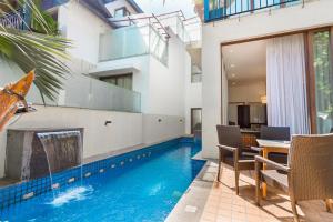 a swimming pool in the middle of a house at Luxury Villa Goa in Candolim