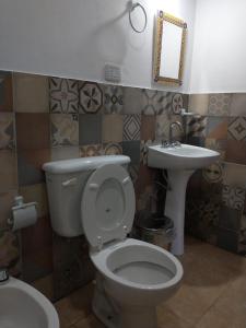 a bathroom with a toilet and a sink at El Remanso in San Lorenzo