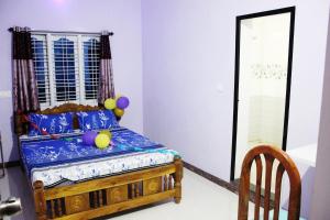 a bedroom with a bed with balloons on it at Hiremane Residency in Sringeri