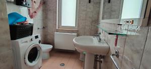 a bathroom with a washing machine and a sink at Casa Vacanze Varuga in Praia a Mare +28 photos