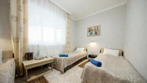 a hotel room with two beds and a window at Mini-Hotel Coral Family in Mostovskoy