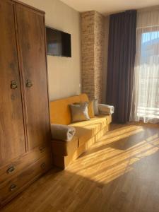 a living room with a couch and a large window at Bansko SPA Studio at Predela1 in Bansko