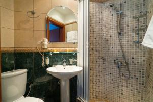 a bathroom with a toilet and a sink and a shower at Villa Edelweiss in Sveti Stefan