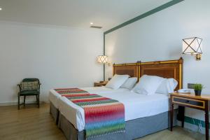 Posteľ alebo postele v izbe v ubytovaní Hotel Don Curro
