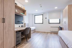 A bed or beds in a room at Micampus Santander Student Residence