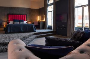 a hotel room with a bed and a couch and a bedroom at 62 Castle Street Hotel in Liverpool