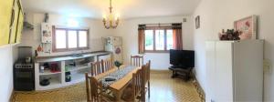 a kitchen with a table and chairs and a refrigerator at Hospedaje Amilcar in Esquel