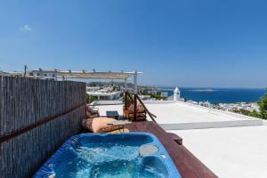 a jacuzzi tub on the roof of a house at Xydakis Apartments in Mýkonos City