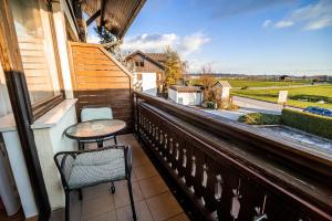 a balcony with two chairs and a table at Guesthouse Leski Dvor in Lesce