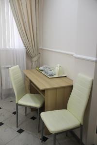 Habitación con mesa, 2 sillas, mesa y sillón en Sokol Hotel, en Sochi