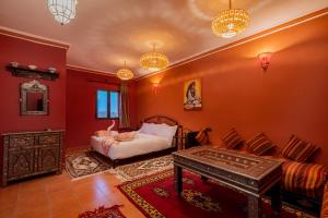 a living room with a bed and a table at Kasbah Hotel Ziz Palace Rissani in Rissani