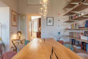 a large wooden table in a room with chairs at HospitalityRome Testaccio Apartment Tiber View in Rome