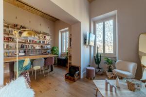 a living room with a large desk and chairs at HospitalityRome Testaccio Apartment Tiber View in Rome