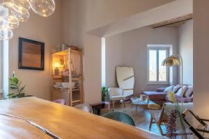 a living room with a table and a couch at HospitalityRome Testaccio Apartment Tiber View in Rome