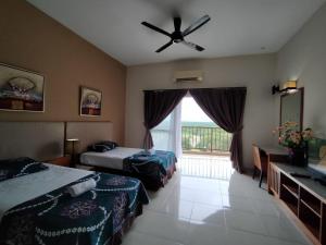 a hotel room with two beds and a ceiling fan at Buluh Inn @ Gold Coast Morib in Banting