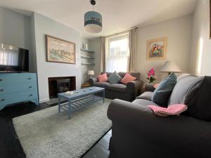 a living room with a couch and a table at Shelley Beach in Deal