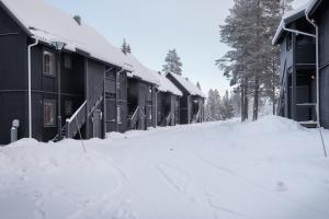 a snow covered street in front of some buildings at Vasabyn Fjällhem in Sälen