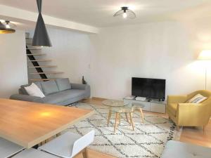 a living room with a couch and a table at Appartement Gambetta in Saint-Jean-de-Luz