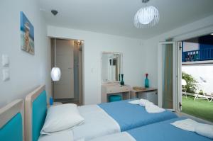 a bedroom with two beds and a window at Mykonos Marina in Mikonos