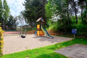 a playground with a slide in a park at Novotel Marseille Est Porte d'Aubagne in Marseille