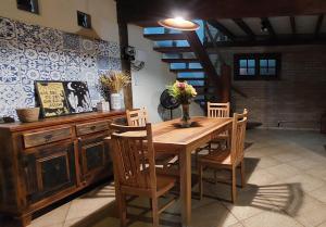 a dining room with a wooden table and chairs at Chalé da Serra in Bragança Paulista