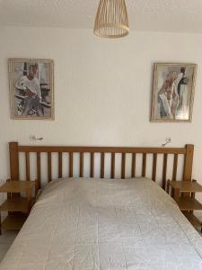 a bedroom with a bed and a painting on the wall at Residence Roc E Mare Cargèse in Cargèse